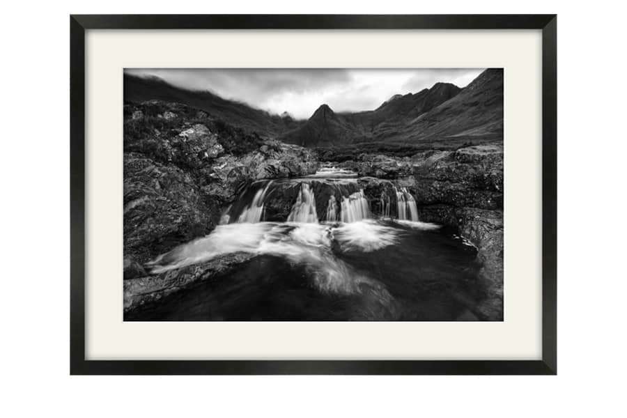 Isle of Skye Fairy Pools in Black and White. Framed artwork in a satin black frame with white mount